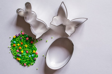 Easter background with cookie cutter and sugar sprinkles 