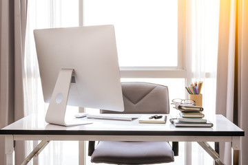 Office desk with desktop computer, cup of coffee and office equipment