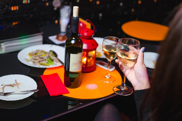 hand holding glass of red wine