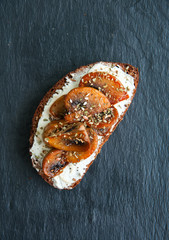 Rye bread bruschetta.  Mushrooms and cream Cheese sandwich served on a stone board on blue background. Close up Top View.