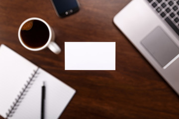 Blank business card design mockup. Visiting card, smartphone and laptop. Business branding template. Cup of coffee.