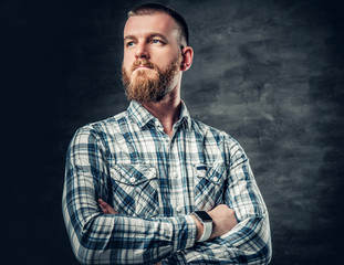 Bearded male dressed in a fleece shirt over grey background.