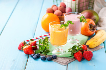 Orange persimmon blueberry smoothie   and fruits. Selective focus. Copy space. Top view