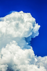 Bright blue sky and fluffy beautiful clouds. Nature background, wallpaper.