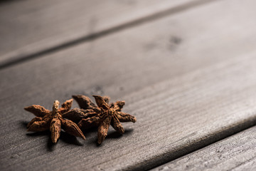 close up view of aromatic anise stars on wooden table