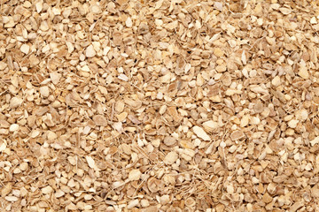 Dried and cut Organic Ginger root (Zingiber officinale) for Infused Tea. Macro closeup background texture. Top view.