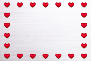 Red hearts. Valentines day. Symbol of love. Romantic greeting background. On white wooden table.