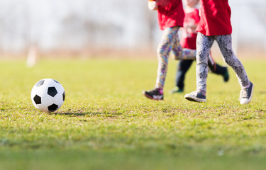 Obraz na płótnie Canvas Kids soccer football - children players match on soccer field