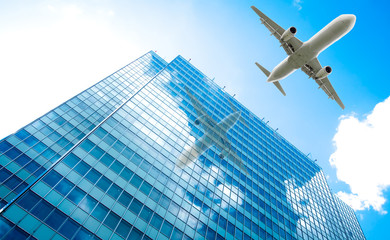 Fototapeta na wymiar aeroplane flying over the skyscrapers. architecture building with flying airplane