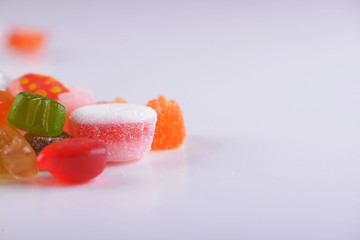 Close-up of candies and candies of various types and flavors on white background. Sweet. Copy-space.
