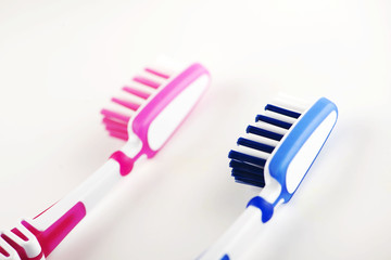 Close-up of toothbrushes on white background. 