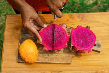 girl peel red dragon fruit. culinary workshop. cooking class