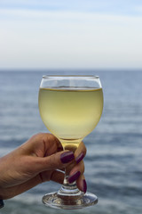 women hand holding a glass of wine