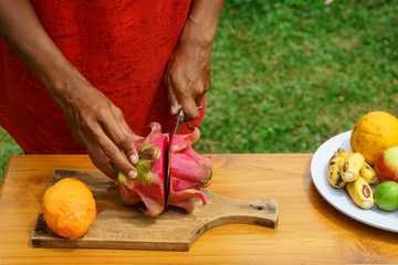 girl peel red dragon fruit. culinary workshop. cooking class