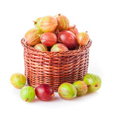 gooseberries in a wooden bowl. Gooseberries fresh berries. red green gooseberry on white