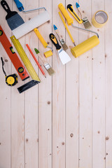 Top view of set of construction tools on wooden table