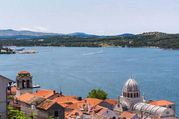 Obraz premium Birds view of the bay of adriatic resort Shibenic. Yachts in harbor and red roofs of houses, of old mediterranean town.