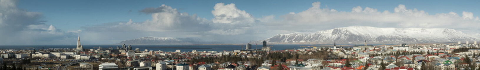 Panorama of Reykjavik skyline showing Hallgrimskirkja church cathedral and the mountains in the...