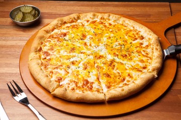 Cheese pizza on a wooden board