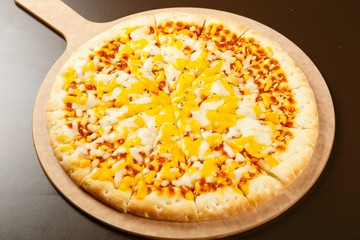Cheese pizza on a wooden board