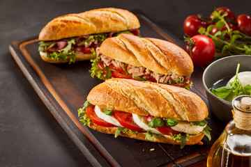 Freshly made gourmet sandwiches on wooden tray
