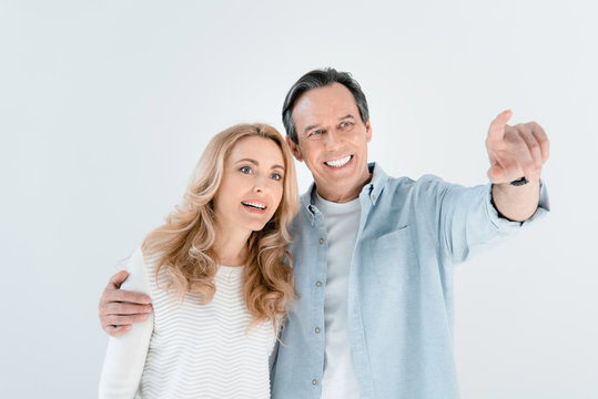 portrait of smiling stylish mature man and woman on white