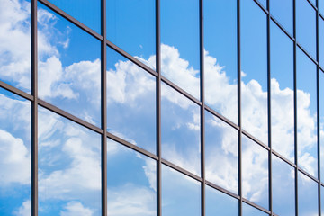 Sky and clouds reflected in building glass facade