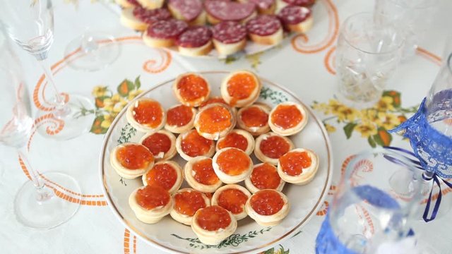 Caviar canape' on luxury table. Red Caviar And Fish Strawberries On Table. Beautifully Decorated Catering Banquet Table With Canape With Caviar. Salmon Steak And Red Caviar. Vegetable caviar in a