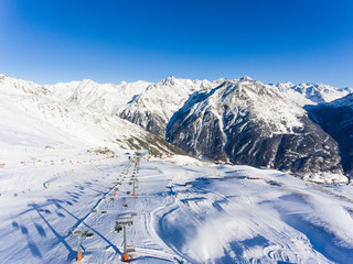 Skiers and ski lifts in Alpine ski resort in Solden in Otztal Alps, Tirol, Austria