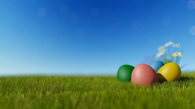 Colorful Easter eggs on green meadow over blue sky