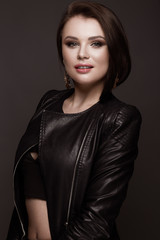 Beautiful woman with evening make-up and long straight hair . Smoky eyes. Fashion photo. Picture taken in the studio on a black background.