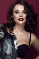 Beautiful woman with evening make-up, dark lips and long curls hair . Smoky eyes. Fashion photo....