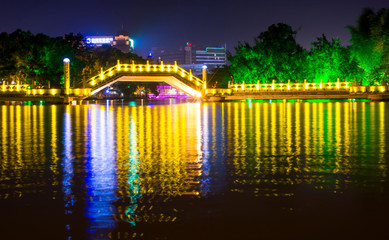 Huizhou Jiuqu bridge on the artificial lake in Guilin travel area with tourists walking