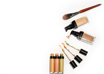 Light beige color liquid concealer closed and open bottle and brush, used for covering blemish on the skin, isolated on white background, with clipping paths