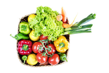 Vegetables in basket on white background