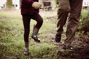 Fototapeta na wymiar Grandfather and granddaughter running outdoor.