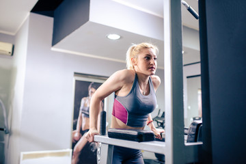 Fototapeta na wymiar Sexy blonde woman working out at gym
