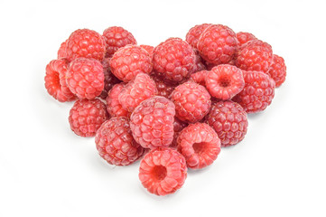 Heart shaped red raspberries isolated on white