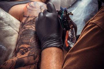 Master doing tattoo in studio
