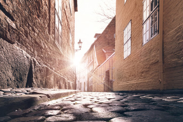 low angle view of sunset in old town alley cobblestone street surface © Christian Horz