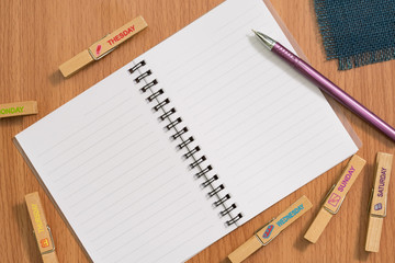 Blank notebook and pen on wooden desk for any idea on desk work.