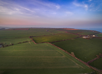Naklejka premium Sunset above fields