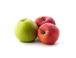 Two red and one green ripe apples on a white background..