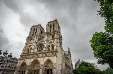 Fototapeta na wymiar Notre Dame Cathedral in Paris with dark clouds