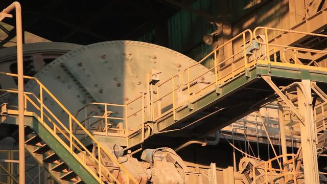 A ball Mill inside of a copper processing industry.
A ball mill, a type of grinder, is a cylindrical device used in grinding (or mixing) materials