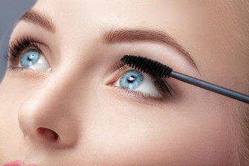 Mascara brush close up.  Make-up for blue eyes. Mascara applying