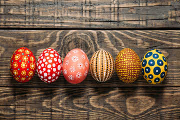 Colorful Easter eggs on wooden background