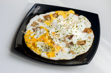 fried eggs with toasts and chopped  parsley