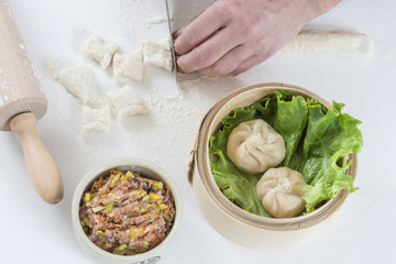 Hands preparing homemade dim-sum asian dumplings