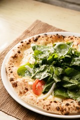 arucola pizza on table